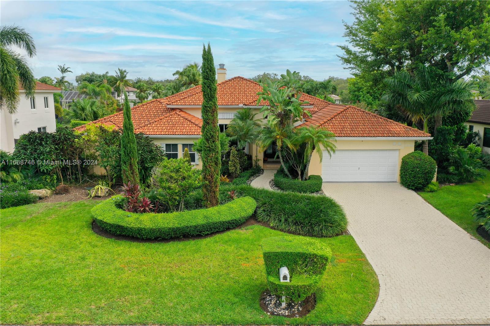 Enchanting home in gated community of "Flamingo Gardens". Custom front doors. High ceilings. French doors open to pool/patio & "beachfront canal", 8 foot deep pool. Granite & stainless kitchen. Italian tile & wood floors. Covered patio. Outdoor lighting. Side garden offers a nice and relaxing escape. Opulent landscaping. Wood burning Fireplace. The roof is from 2006.Two AC units changed 2018 & 2020 Accordion hurricane shutters on all openings.