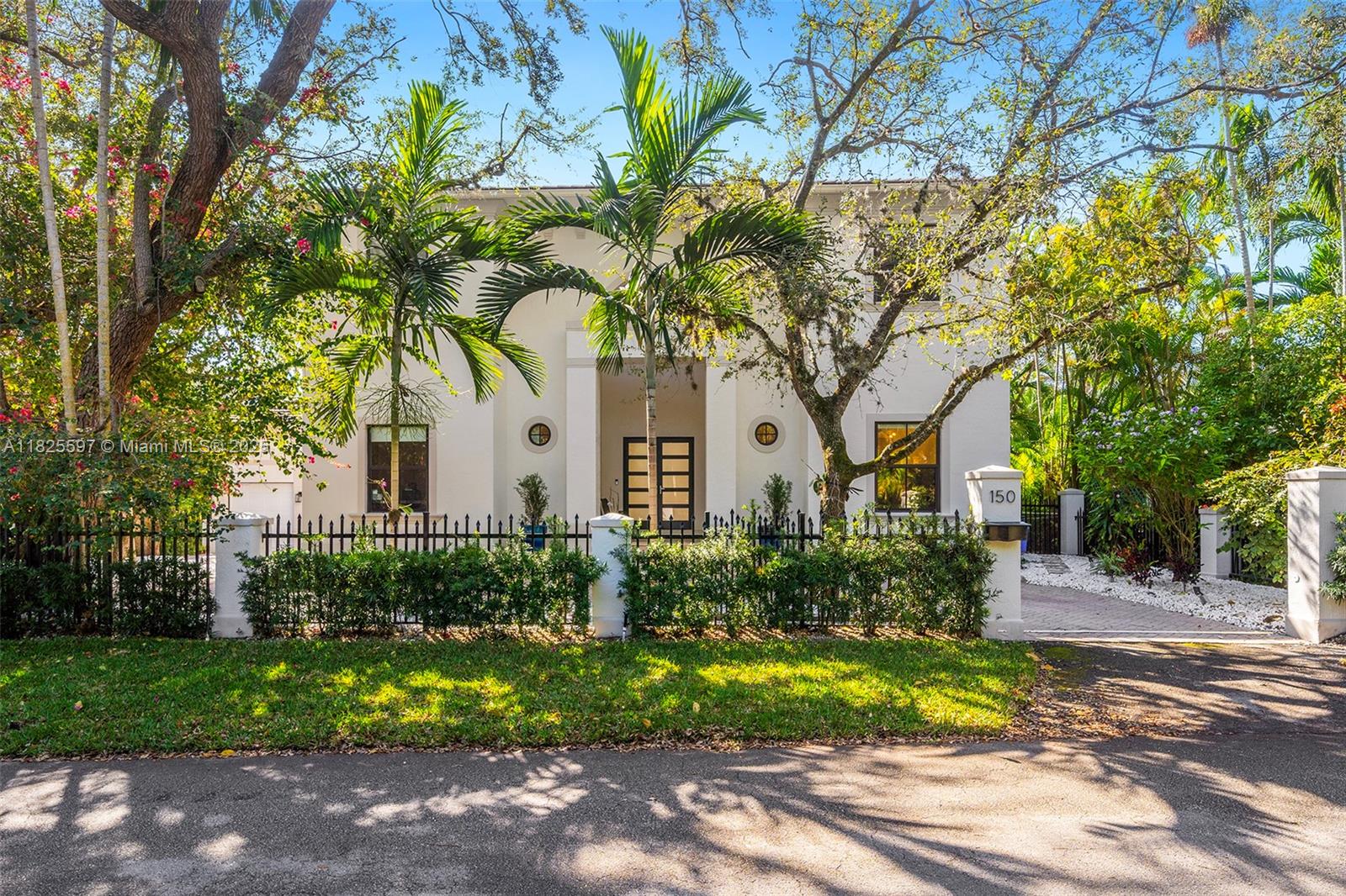 This refined & elegant retreat is thoughtfully crafted to provide comfort and complete tranquility. The grand foyer entry opens to an expansive floor plan seamlessly integrating indoor & outdoor living. 23' high ceiling living room with floor-to-ceiling windows offers serene views of the pool and courtyard. Modern kitchen features high-end appliances, white quartz island & a breakfast bar, all flowing into the family room—perfect for entertaining. The primary suite on the first floor boasts a luxurious spa-inspired bathroom, a walk-in closet & glass doors that lead to the pool and patio. Two additional bedrooms are upstairs, each with en-suite bathrooms. The home is complemented by a spacious driveway and a two-car garage. This property truly embodies the charm and beauty of Coral Gables.