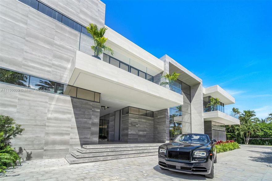 Chic contemporary design unlike anything ever seen! The one-of-a-kind, Smart Home Villa Acqua Azzurra in Golden Beach is laid across three lots totaling 33,750sf, with resort-style amenities comprised of one lot, making it among the largest outdoor areas in South Florida. The fully Furnished by Bentley, Fendi, Trussardi, Minotti, open concept 13,200sf Villa includes 6 beds, separate entrances for office tower & service quarters, 8.5 baths and Entertainment room. Two luxurious Master Suites, his/her closets, Waterfall Jacuzzi, Full Bars, Food Elevator. 48-foot Chef’s Kitchen180-Bottle Wine wall & Bar featuring a sliding Glass wall to showcase prestigious Vehicles. Expansive outdoor Sanctuary includes 2400 sf salt system 2 Pools, Jacuzzi, 3430 sf total Pool Deck Spa/Sauna & outdoor kitchen.