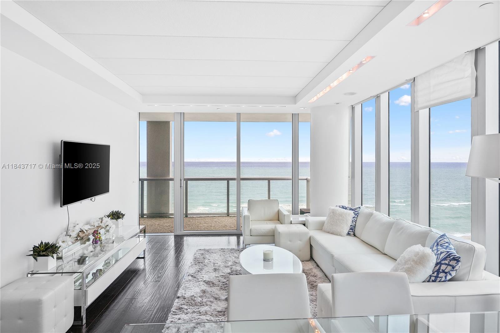 Experience stunning ocean, bay, and city skyline views from this spacious 2-bedroom, 2-bath residence at Carillon. The open living area features floor-to-ceiling windows that flood the space with natural light, while two private terraces—one for sunrise, one for sunset—offer perfect settings to enjoy breathtaking views throughout the day. Each room opens to a terrace, blending indoor and outdoor living. Thoughtfully designed, the home includes custom walk-in closets and electric blinds for added comfort and convenience. Residents enjoy world-class amenities, including a 70,000 sq. ft. spa and fitness center, daily wellness classes, four swimming pools, beach and poolside service, concierge, and more—5-star resort-style living in the heart of Miami Beach.