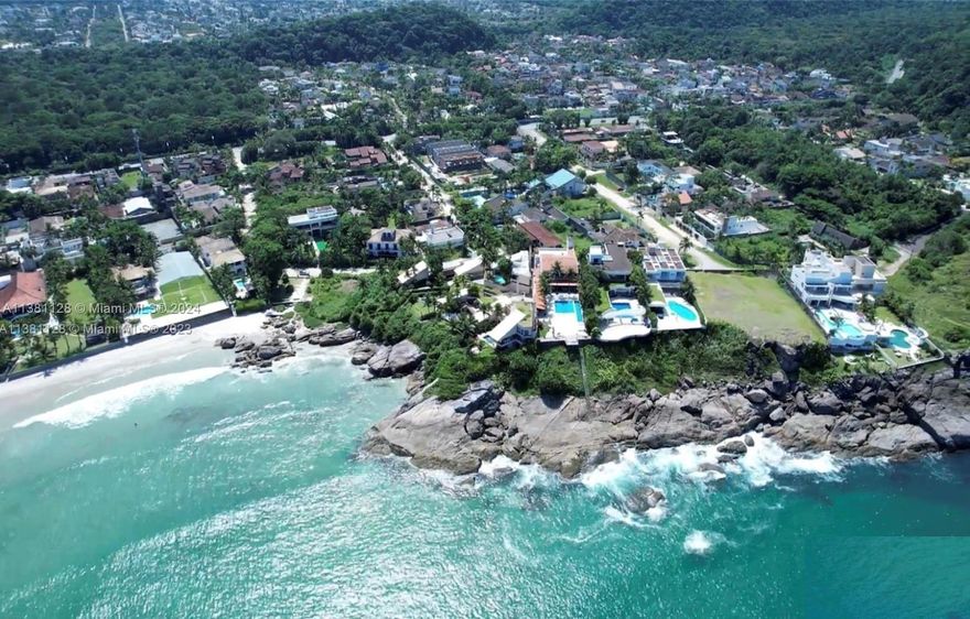 Magnificent Luxury Home 360-degree ocean view at the city of Guarujá,São Paulo,Brazil.Three floors mansion built in extraordinary location,overlooking the sea,at the Coast,solid construction,designed w 2 fronts,facing the sea,and Atlantic Forest,w most extraordinary views.All work was built with bricks of pottery to maintain the temperature according to the climate Walls built with natural stones extracted from the land itself transforming architecture,elegant contemporary contrasts w fine finishes,facada w natural stones(canjiquinha),10 suites,whirlpools,panoramic elevator,social room Greek Piguês marble flooring,security system,monitored w cameras and guardhouse,1.600 sqm² built.(17.222 SF).R$25,000,000.00 (Reals).