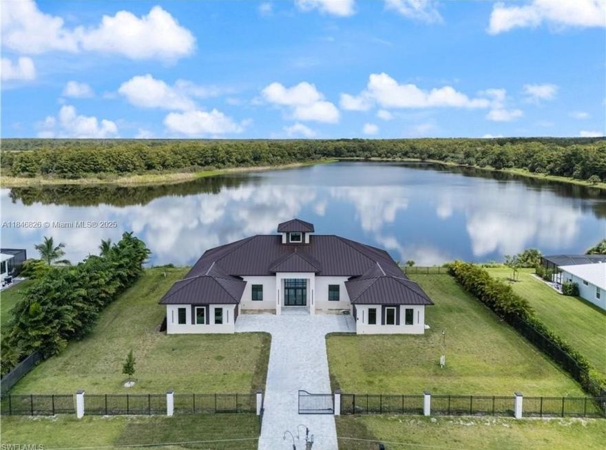 Spectacular lakefront pre-construction home! This 5,375 SF modern residence will be built on a premium lot in Golden Gate Estates, featuring 4 bedrooms, office, 5 bathrooms, open floor plan, high ceilings, gourmet kitchen with island, panoramic windows, premium finishes, private pool and 4-car garage. Positioned directly on a lake with expansive views. Model home available for private tours. Experience elevated living in a tranquil, water-oriented setting!