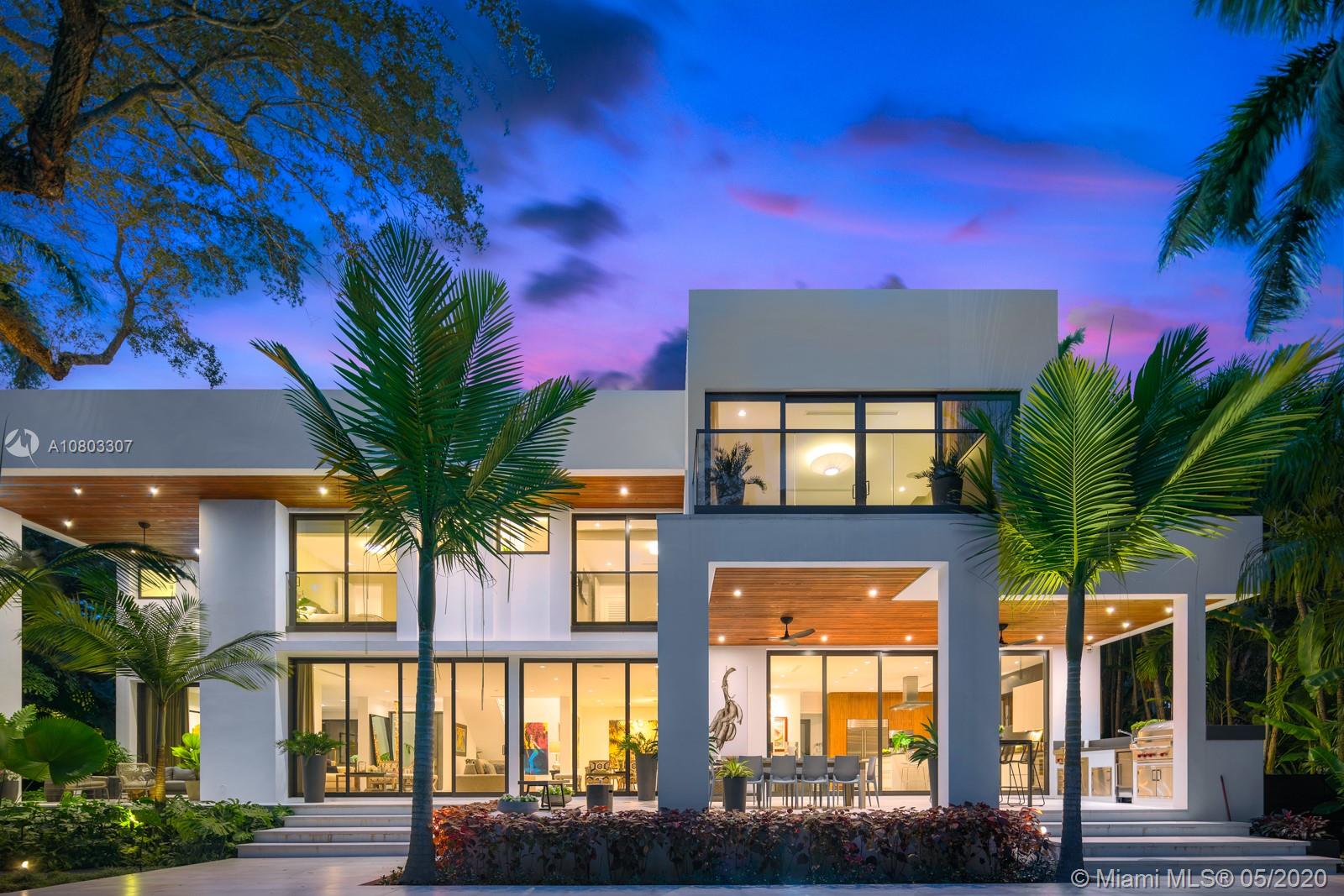 Embrace this 6,784 total sf two-story sustainable modern masterpiece on a 15,912 sf lot, designed by Jose Sanchez of Praxis Architects. Perfectly located at the end of a historic, Oak-canopied private cul de sac, this stunning 5BR/5+1BA eco-smart home has a water filtration system, porcelain floors, and tinted impact windows/doors throughout. Smart features include Creston lighting, Sonos sound, cooling, 8 camera security system with alarm, and automatic irrigation on a private network with mobile access/control. Epicurian eat-in kitchen with 2 dishwashers, cooking island, walk-in pantry, and lots of storage is complemented by a gourmet summer kitchen for ideal outdoor hosting. Heated saltwater pool surrounded by marble and coral terraza tropically landscaped by renowned David Odishoo.