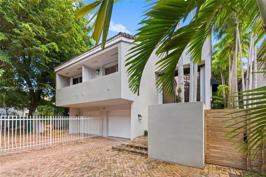 Stunning and spacious 1,815 SQFT 2-Story Townhome with 1-car garage in the heart of Coconut Grove!  Features large windows, allowing lots of natural light, creating a warm, inviting and tranquil atmosphere. Wood flooring throughout. Open kitchen concept with granite counter tops, wood cabinetry and stainless steel appliances. Half bath on the first floor. Living room has a gorgeous view and access to the private patio, lined with brick pavers, manicured landscaping and a retractable awning, creating the perfect setting for outdoor gatherings or peaceful relaxation in nature. Both bedrooms are upstairs, with a spacious primary bedroom with walk-in closet, sitting/office area adjacent. Driveway has additional 2 parking spaces.