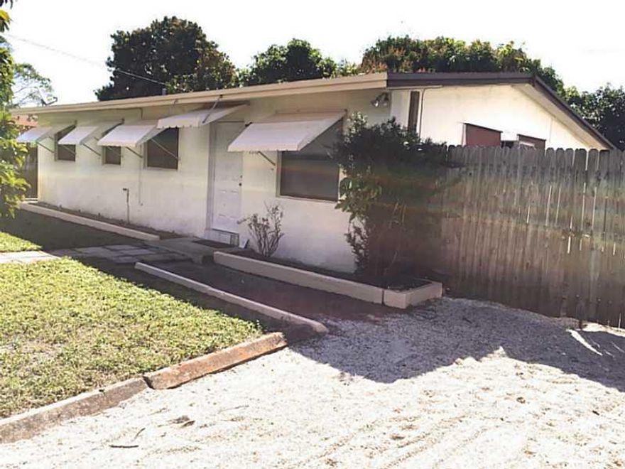 Enjoy a cold lemonade on the Porch of this well maintained Fort Lauderdale home! Bring your small pet and enjoy the luxury of a fenced in yard, perfect for summer BBQ's! Shaded buy two  luscious mango trees, this home comes with a den right off the kitche n and fully equipped full size washer and dryer. Don't let this gem slip away!