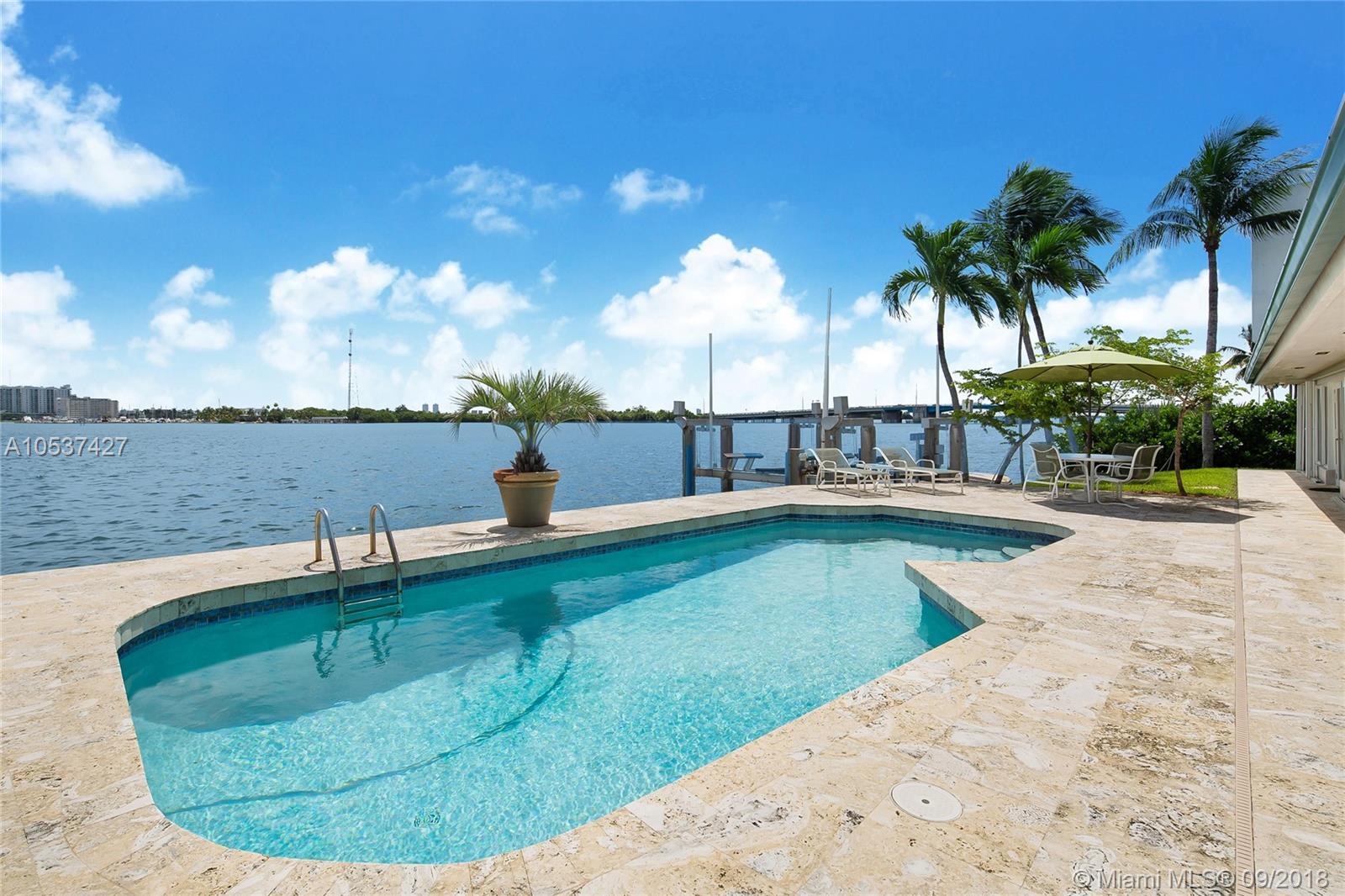 Rare bay front home on the point end of cul-de-sac on quiet street. Spectacular views welcome you, open the impact glass doors to the patio and watch mother nature&#x2019;s abundant beauty every day. Lower your boat from the 40K lb boat lift and reach the ocean in 15 min. Relax in the pool. This split 4 bedroom, 3.5 bath layout ensures privacy. The generously spaced family & dining room are ideal for entertaining adjacent to updated kitchen. There is plenty of closet space and an oversized 2 car garage. Impact windows throughout. No worries if the power fails, there is a 30k watt generator set.  The owners have taken great care of this beauty with attention to detailed maintenance. By appointment only. No sign on the property.