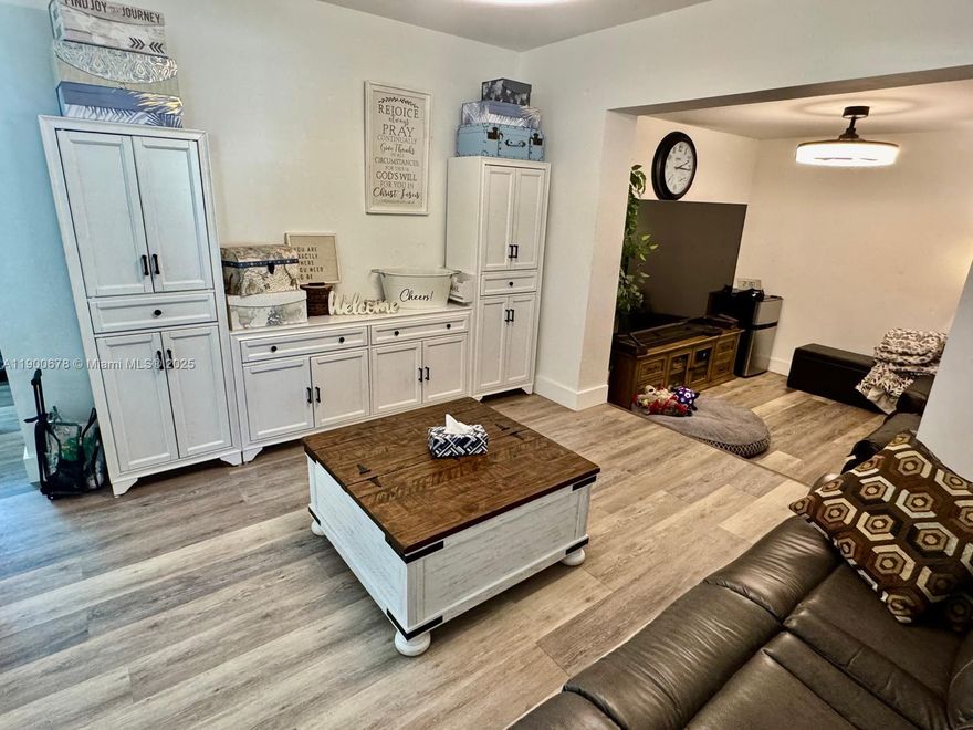 Charming 3-bedroom, 1-bath home with a separate rear unit currently used for storage, offering endless possibilities. Set on a generous 10,500 sq ft lot at the end of a quiet cul-de-sac. Inside, natural light fills every corner, highlighting high ceilings, new baseboards, and freshly updated finishes. The kitchen features white cabinets, butcher block counters, a wall and standard oven, stainless gas stove, and double sink. Key highlights include impact windows plus accordion shutters, approx 8 yr old roof, 2022 A/C, and gas water heater. The screened porch overlooks a huge backyard with mature trees, including a mango tree. Additional perks include a spacious laundry room/pantry and transferrable PACE energy-efficient upgrades.