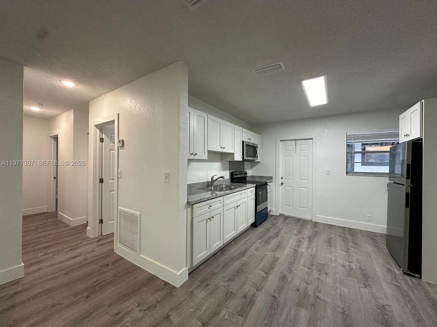 Brand-new, charming 2BR/2BA apartment in Hallandale Beach, meticulously remodeled to embody comfort and style. Every detail feels like home, with new elegant finishes throughout—sparkling granite countertops, brand new, high-end appliances, with beautiful lighting and flooring. The spacious, first-floor corner unit boasts an open, welcoming layout perfect for gatherings and entertaining, complemented by big rooms and walk-in closets for ample storage. Has a private laundry/utility room with washer & dryer hookup. Unit includes 1 assigned parking space. Situated in a perfect location in a quiet community with easy access to parks, beaches, shopping & dining. This is a true Hallandale gem—a haven of newness, spaciousness & convenience, where every detail makes you feel right at home.