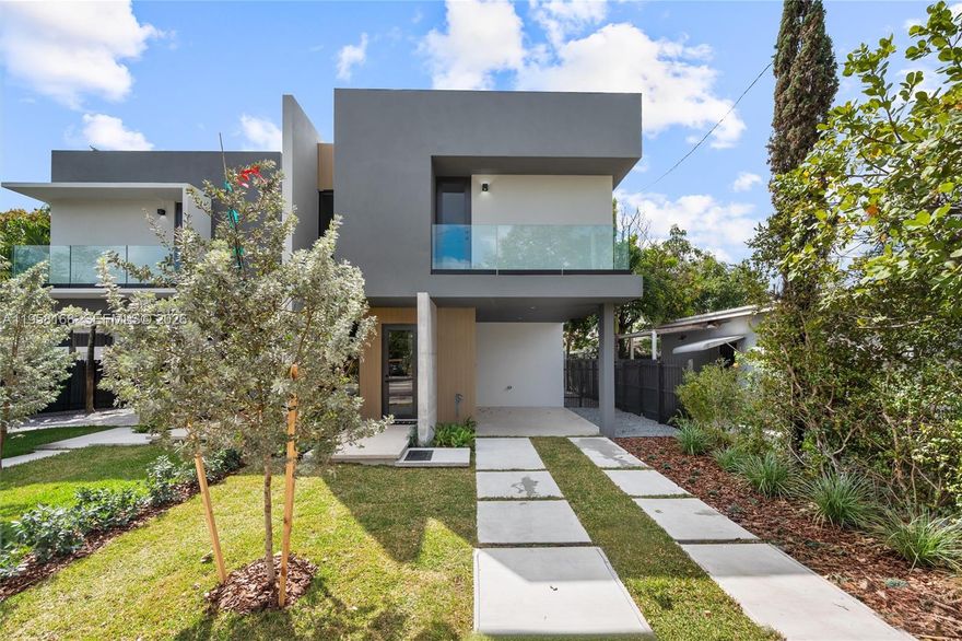 New construction townhome in the heart of Miami featuring 3 bedrooms, 3.5 bathrooms, and 1,691 sq ft of thoughtfully designed living space. This contemporary home showcases clean architectural lines, abundant natural light, and an open-concept layout perfect for today’s lifestyle. The main living area flows seamlessly into a sleek designer kitchen with custom cabinetry, quartz countertops, stainless steel appliances, and a large center island with seating, making it ideal for both entertaining and everyday living. Floor-to-ceiling glass doors bring the outdoors in and open to a private fenced backyard. Upstairs, the spacious primary suite features large windows, serene views, and a spa-inspired bathroom with modern finishes and a glass-enclosed shower. Each additional bedroom offers its own bathroom, providing comfort and privacy for family or guests. Additional highlights include high ceilings, modern lighting, impact windows and doors, balcony access, in-unit laundry, and a private yard perfect for relaxing or entertaining. Conveniently located near dining, shopping, and major Miami attractions. Experience modern Miami living in this beautifully designed home.