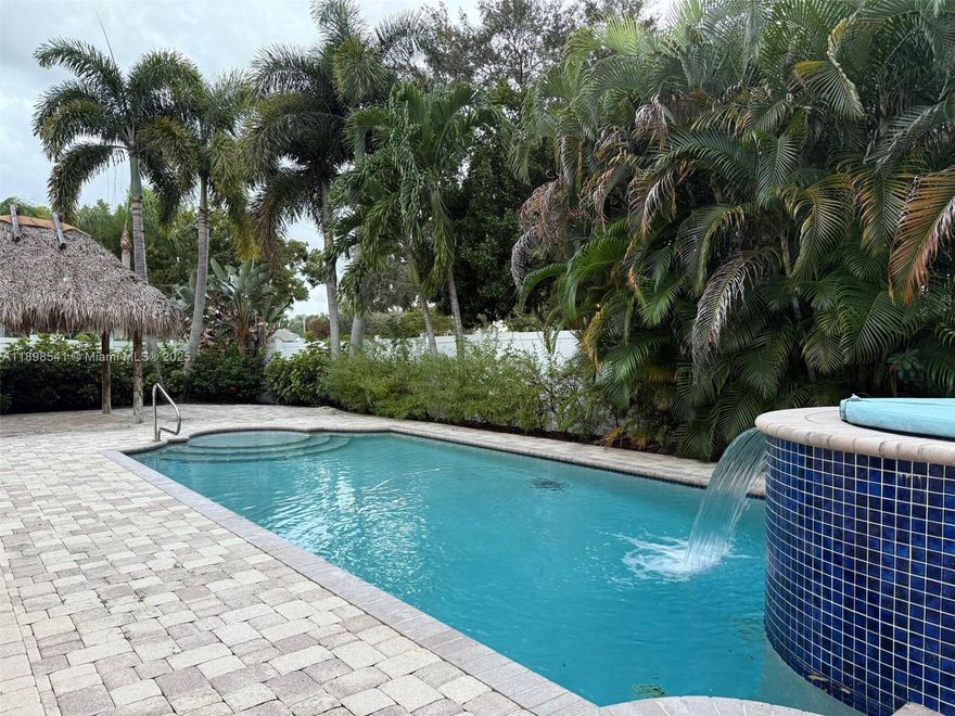 Welcome to your private South Florida Oasis- with a heated saltwater pool with a waterfall, an oversized lot, an outdoor shower and amazing Tiki hut for shade and privacy! 2 car garage, and everything you need for a comfortable lifestyle. 3 bedroom + 2.5 bathrooms, upstairs den has been converted into a 4th bedroom, plus an office space downstairs with sliding glass doors that can be used as a guest bedroom. Large custom-built walk-in closet in the master bedroom plus another walk-in closet in the guest bedroom. Hurricane shutters. Nautica gated community has a low HOA fee and offers a heated pool, clubhouse, gym, tennis, basketball, pickleball courts and social events. A must see!