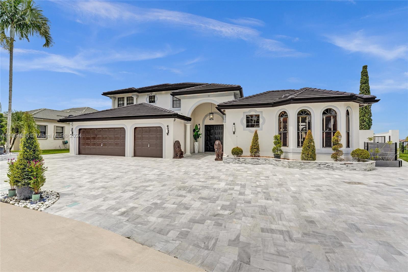 Welcome to your dream home in the prestigious Sunset Lakes community! This beautifully remodeled 7-bedroom, 5-bath Courtyard residence features an elegant open floor plan with high-quality marble flooring throughout. NEW PAINT inside and out, the home boasts a NEW TILE ROOF and NEW GUTTERS, NEW BALCONY overlooking the lake and pool. Stunning kitchen with modern appliances and Calcutta quartz countertops. The charming ATTACHED GUEST HOUSE includes a bathroom and walk-in shower, ideal for visitors. Expansive windows fill the home with natural light, showcasing the exquisite MARBLE PATIO & PERGOLA and new NEW SALT POOL. Lake views provide a picturesque backdrop, spacious courtyard is perfect for entertaining. Don’t miss this opportunity to own a spectacular retreat in a sought-after community