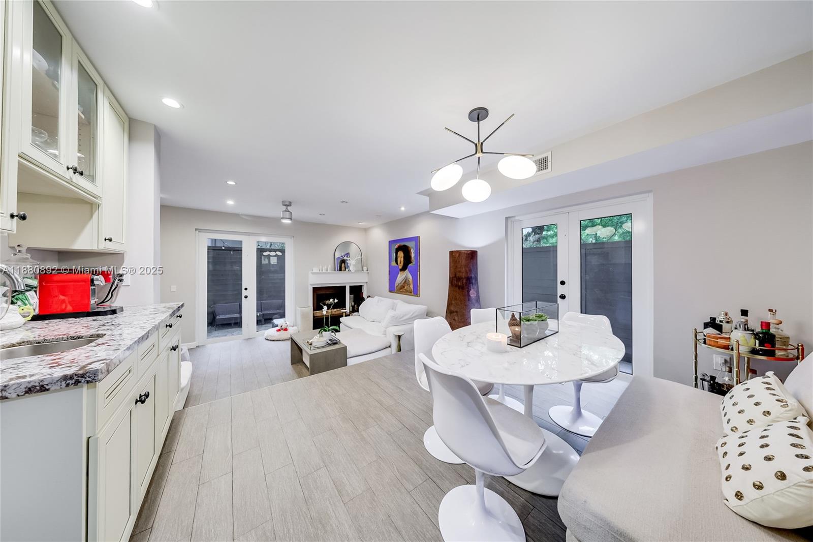 Welcome to this charming 2-story condo in the heart of Coconut Grove. Featuring 2 bedrooms and 1.5 bathrooms, this adorable unit blends comfort with thoughtful updates. The kitchen was updated with new cabinets in 2021, and the roof was replaced in 2023 for peace of mind. A cozy fireplace adds to the charm, while a wet bar makes entertaining a delight. Enjoy the convenience of an in-unit washer and dryer, plus two unassigned spaces in a gated parking lot. The private patio is perfect for relaxing outdoors, and the boutique building of only four units offers an intimate, quiet setting. Located near parks, marinas, shops, and dining, this move-in-ready condo captures the vibrant Coconut Grove lifestyle with ease.