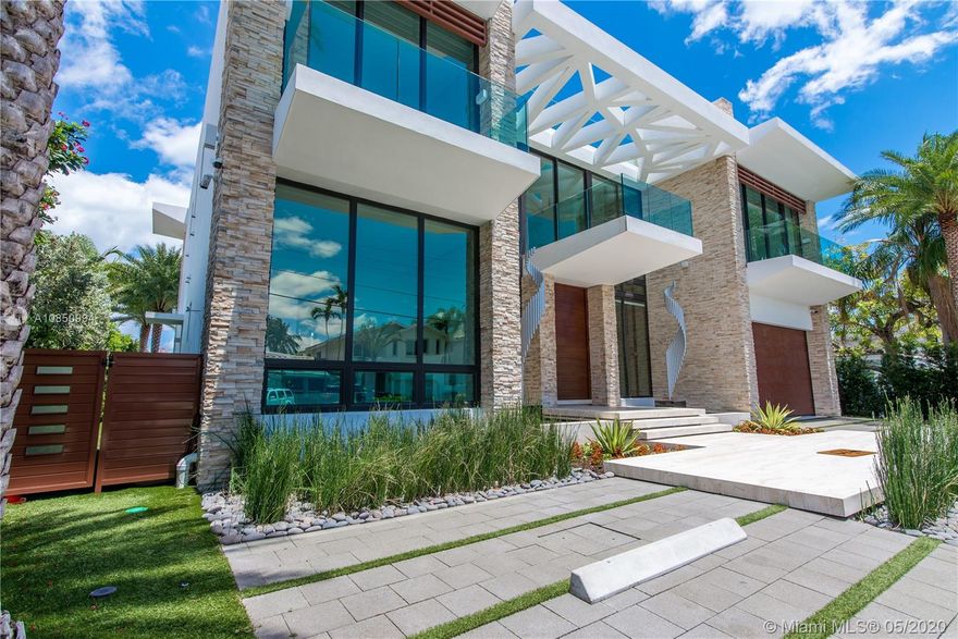 Spectacular Ultra Modern custom-built waterfront home in the upscale community of Eastern Shores. Built 2018. Top-of-the-line line craftsmanship with concrete floors, roof and sun deck. Amazing High ceilings with floor-to-ceiling windows and sliding doors. Entrance has pivot door. Elevator car with glass. Porcelain floors thru-out.  80 kilowatt emergency generator. Home has many full automation features. Electric shades throughout. Built-in bar with floor to ceiling wine cooler. 
Designer state of the art kitchen with Caesarstone quartz countertops and backsplash w/Antolini black marble slabs. Outdoor patio gazebo features stainless cabinets and appliances w/ barbecue. Large wet edge pool with Spa. Dock up to 80-foot yacht. Spacious Master has a large sitting area with a huge terrace.
