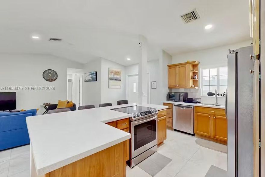 Discover this charming 3-bedroom, 2-bathroom single-family home offering 1,197 square feet of comfortable living space in desirable NW Lauderhill. Nestled on a quiet cul-de-sac street with no through traffic, this residence provides the perfect blend of privacy and convenience.
Step inside to find a bright, open floor plan enhanced by soaring vaulted ceilings and abundant natural light streaming through oversized windows. The freshly painted interior in neutral tones creates a move-in ready canvas for your personal style. The inviting kitchen features warm wood cabinetry and modern stainless steel appliances including refrigerator, dishwasher, microwave, and self-cleaning oven.
The thoughtful layout includes a main-level master suite and stacked secondary bedrooms. Tile flooring flows through the main living areas while vinyl flooring complements the additional bedrooms. Enjoy seamless indoor-outdoor living through double-pane patio doors that open onto a screened lanai overlooking the expansive, fully fenced backyard complete with a mature fruit-bearing avocado tree, firepit, and play area perfect for entertaining.
Additional highlights include one car garage, washer/dryer, and an entrance foyer. Ideally located between University Drive and Pine Island Road, you're minutes from Sawgrass Mills Mall, diverse dining, and entertainment. Easy access to major highways makes commuting a breeze. Don't miss this opportunity to call this welcoming home yours!