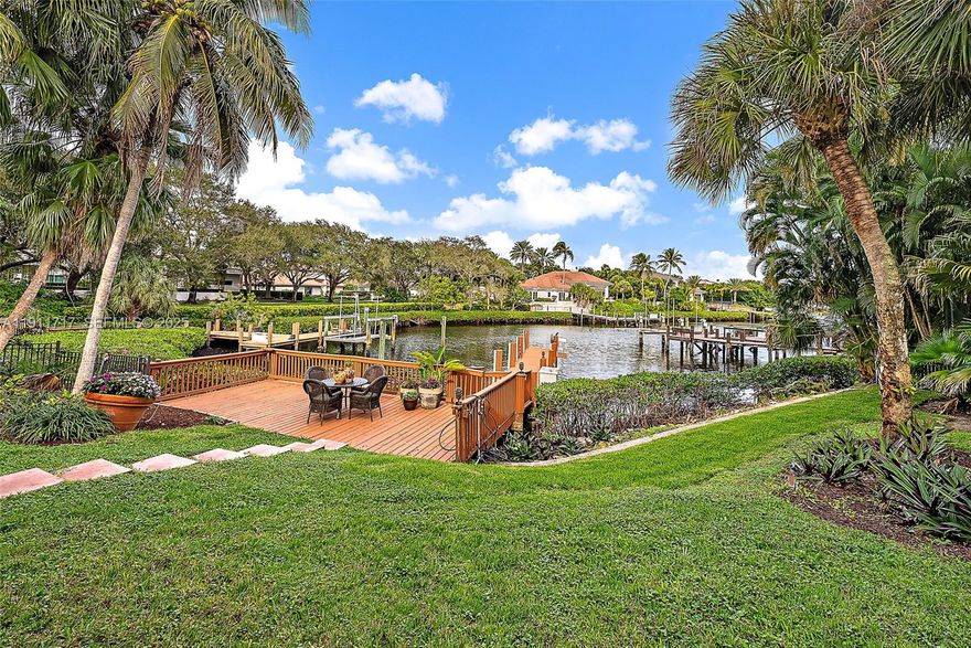 Nestled in the prestigious Admirals Cove community, this exceptional residence offers a blend of luxury and tropical charm. Step into a beautifully designed courtyard that welcomes you with warmth and elegance, leading to a spacious guest house perfect for visitors or extended stays. The home boasts a large kitchen ideal for entertaining, while the expansive living areas open to a breathtaking long waterway view that captures the essence of waterfront living. Enjoy the ultimate in outdoor relaxation at your private tiki bar, surrounded by lush landscaping that ensures complete privacy and serenity. With four car garages providing ample space for vehicles and storage, this property combines functionality with refined style in one of Jupiter's most sought-after neighborhoods.