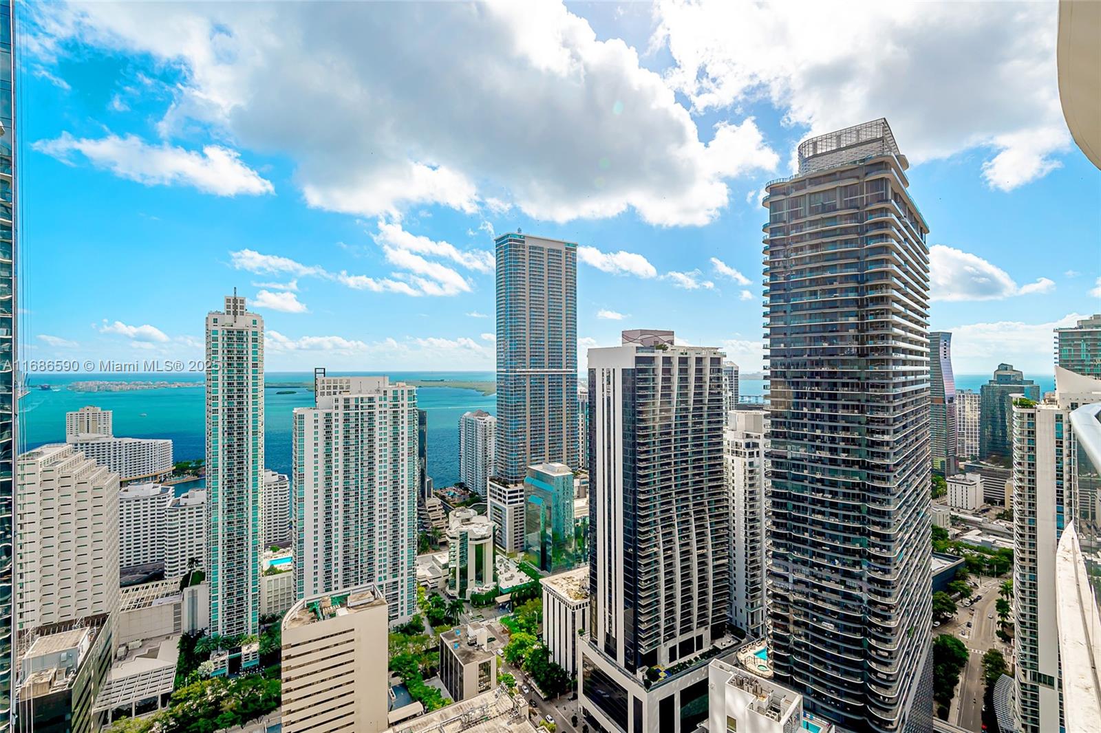 - REDUCED - Spacious and Open Eastern Corner 3/3.5 Lower Penthouse at Brickell Heights East. Stunning views, 12'+ volume ceilings, 3 Full En-Suite bedrooms in a split plan all with room darkening shades and custom closet cabinetry, a separate den/office/dining area plus another 4th half bath for guests. Main suite with dual sinks, separate tub and large walk-in shower. Expansive balcony wrapping the entire residence offering miles of extensive views east, south, north and west - in the heart of everything Brickell. 2 assigned self-parking spaces with lift. Equinox, Soul Cycle, Sweat440 all just downstairs, plus Publix a half block away. 1 block to MetroRail and MetroMover. Easy to show - Text Listing Agent with your contact info to schedule or use ShowingTime.