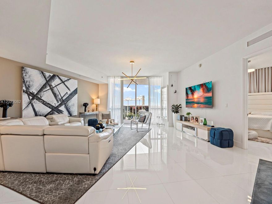 This luxurious two-bedroom, two-bathroom oceanfront lanai condo offers 1,850 square feet of living space, complete with an oversized private terrace that opens directly to the pool deck. With the charm of a beach house, it features a soaring living room ceiling and stunning views through 10-foot floor-to-ceiling windows. The spacious master suite includes its own bathroom, while the modern kitchen is perfect for entertaining. Exclusive beachfront perks include private beach chairs, an oceanfront gourmet restaurant with delivery right to your spot, a lavish clubhouse, a state-of-the-art gym, his and her spas, two lap pools with attendants, valet service for two cars via an on-call app, and a business center. The property also boasts a spectacularly renovated patio and pool area.