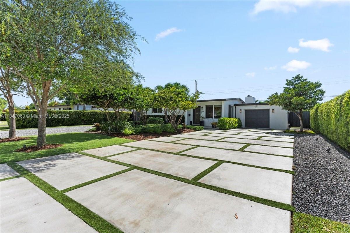 Beautifully remodeled and move-in ready, this home offers a series of upgrades perfect for everyday comfort and entertaining. The expanded driveway fits 8+ vehicles, complemented by an oversized garage with plenty of storage. Step into the backyard oasis featuring new turf, a full sprinkler system, and a sparkling pool — the ideal setup for hosting. Inside, enjoy a custom bar, a fully updated kitchen with modern finishes, and an open layout that brings it all together. A turnkey opportunity in a prime Miami location.