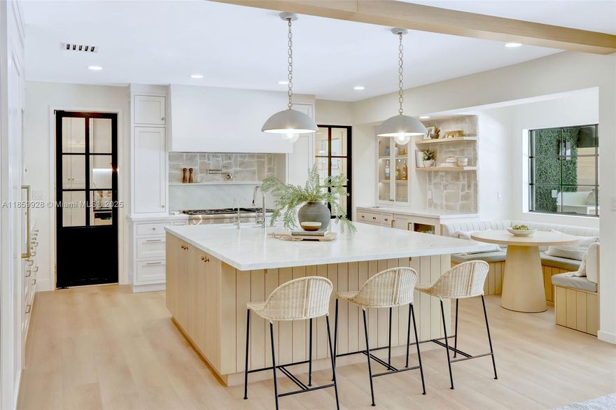 Stunningly updated Pinecrest home designed for connection, comfort, and warm-weather entertaining. This 4BR, 3BA layout lives like six, with a flexible lounge off the kitchen for play or study, and a private office within the guest suite. At its heart, a truly custom chef-inspired kitchen with a large island, deluxe Thermador appliances, wine storage, rift cut white oak cabinetry, built-in banquette, and a walk-in pantry makes mealtimes a joy. The open living space brings everyone together, and away from screens, whether for dinner or downtime. Outside, enjoy Miami lifestyle with a heated saltwater pool and summer kitchen featuring a waterfall-edge bar, ice maker, hibachi grill, and more. Impact windows, smart security, and top-rated Pinecrest schools complete this turn key gem.