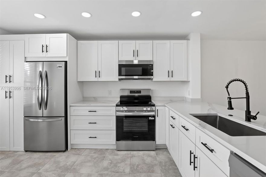 Gorgeous, fully renovated unit in the desirable Cambridge section of Century Village. This stunning home features a brand-new kitchen with premium quartz countertops, new appliances, sinks, and updated plumbing fixtures throughout both the kitchen and bathrooms. Thoughtful details include pantry pull-outs, a pull-out garbage can, and built-in sponge storage for maximum convenience.
Walls have been removed to create a bright, open, contemporary layout. Enjoy all-new electrical with modern high-hat lighting and brand-new luxury vinyl flooring in the bedrooms. Located on the 4th floor, this unit offers beautiful golf course and water views. Move-in ready and truly a must-see — come be impressed! SOME PHOTOS ARE VIRTUALLY ENHANCED.
