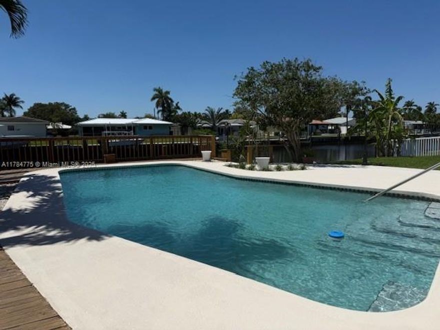 INCREDIBLE REDUCTION PRICE. BUYERS AND INVESTORS - BEAUTIFUL & Luxurious waterfront estate on wide canal w/ocean access l! Boater's Dream!  Remodeled 3-bed, 2 bath single-family home close to beach, shopping,  highways. Modern kitchen with high-end appliances. The split-bedroom layout offers privacy, main bath includes a double-sink vanity. Incredible sunsets. lushly landscaped backyard. The entertainer's dream with private pool and dock—perfect for waterfront living. No HOA! 
Magnificent West Water views from large Family Room. High impact doors & windows - A/C duct system - Natural gas, gas range and water heater - Custom kitchen kalamata quartz countertops/backsplash, island w/cabinetry under the counter top- new bathrooms w/LED lighting - CIRCULAR driveway -  BEST LIVING STYLE!