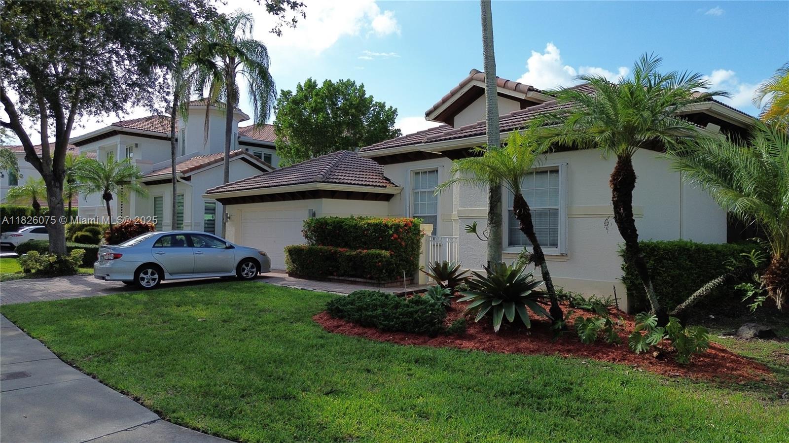 No ASSOCIATION APPROVAL REQUIRED. One-story corner home located in the highly sought-after gated community of Doral Isles. This freshly painted residence offers 4 spacious bedrooms, 3 full bathrooms, and a beautifully remodeled kitchen featuring modern cabinetry and stainless steel appliances. Elegant laminate floors throughout, a generous master suite with a fully renovated spa like shower, and plenty of natural light. Enjoy expansive backyard partially covered patio perfect for entertaining, and a lush green area ideal for kids. 2-car garage plus 2 additional parking spaces in the driveway. Enjoy the resort-style amenities of Doral Isles including 24/7 security, clubhouse, gym, pools, tennis courts, and more. Close to A+ schools, shopping, dining, and major highways.