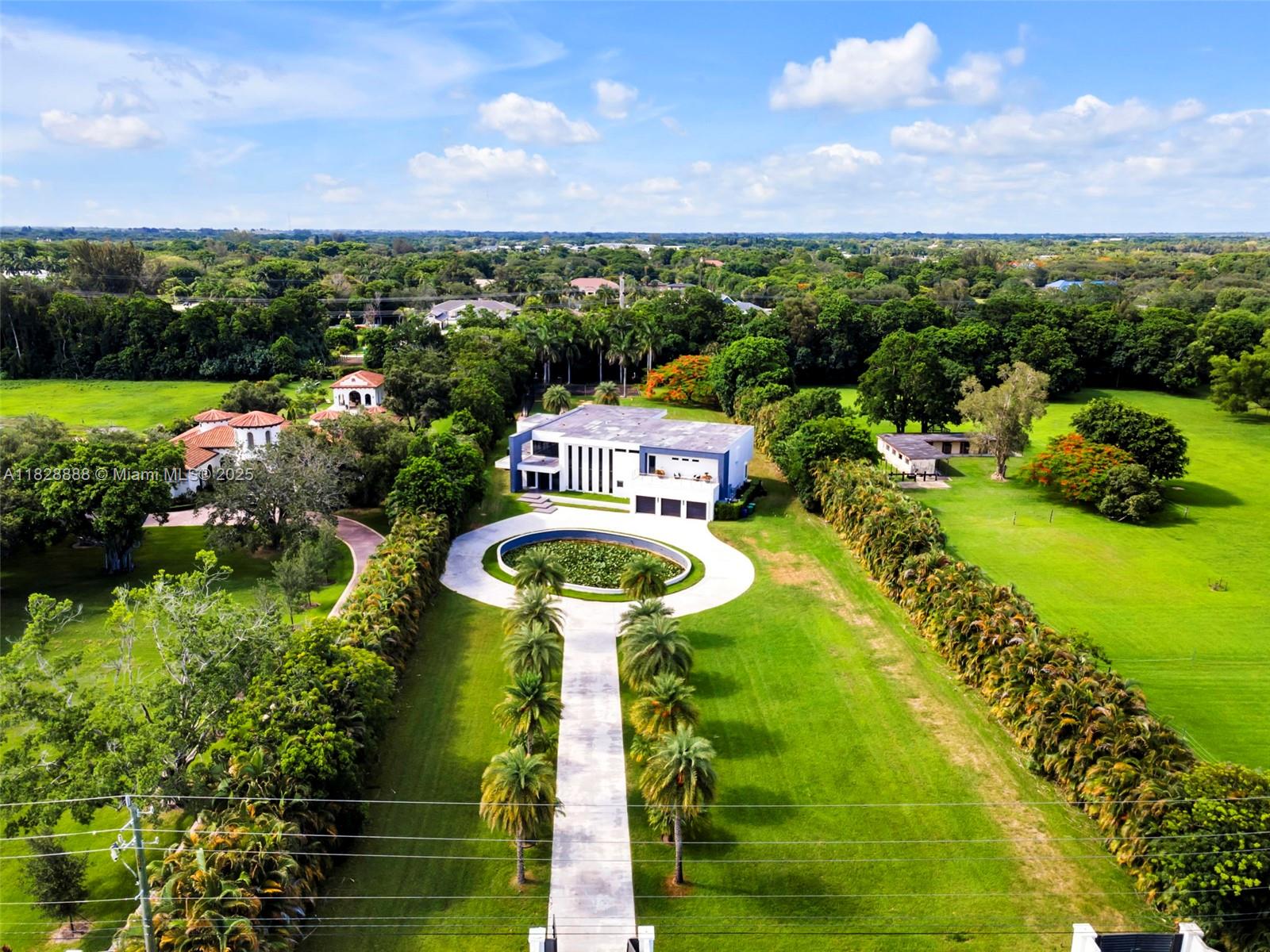 Located on 2.3 acres in the prestigious Southwest Ranches community, this 9,000+ sq ft modern estate blends resort-style amenities with sleek design. The home features 6 spacious bedrooms, 7 bathrooms, a home theater, private gym, and a bright open layout with soaring ceilings and designer finishes. Outdoors, enjoy a stunning pool, full basketball court, batting cage, and plenty of space to entertain or relax in total privacy. A rare opportunity to own a contemporary masterpiece with unmatched amenities in one of South Florida’s most exclusive neighborhoods.