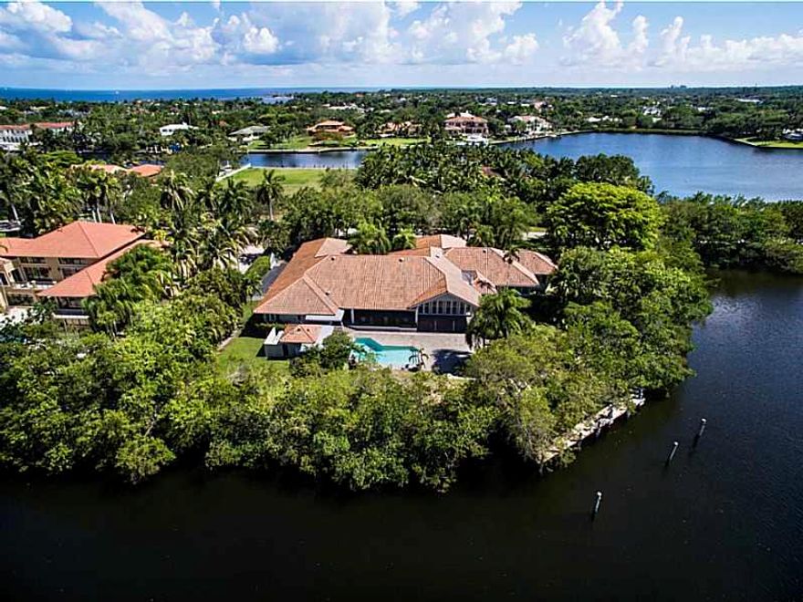 With stunning expansive waterfront views, this home is situated on a rare peninsula in esteemed Gables Estates. The home features a grand entry, high ceilings, spacious and bright living areas, and views from every room. The large eat-in kitchen has high  ceilings, lots of cabinetry, and a walk-in pantry. Relax in the grand master suite with his and her walk-in closets and spa-like bath. The back of the home is lined with French doors that open to a patio and pool, all overlooking the water and boat dock.