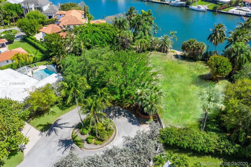 Wide water views and no bridges to Biscayne Bay. Serene waterfront lot, cleared and ready to build in the beautiful gated community of Old Cutler Bay. The lot is positioned in the nook of a cul-de-sac, and offers a sprawling tropical backyard and surrounding mature landscaping. A boater’s dream with more than 120 ft of water frontage, a boat lift and desirable prevailing SE breezes in backyard. APPROVED PLANS AVAILABLE.