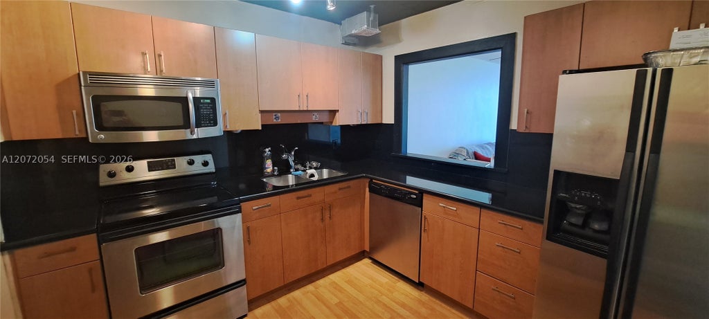 Photo of 427 Golden Isles Dr #5H, Hallandale Beach, FL 33009 (MLS # A12072054)