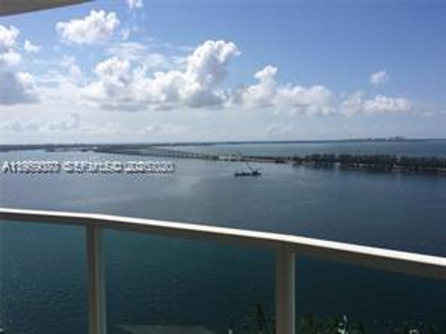 Direct and breathtaking bayfront views from this corner 2/2 spacious unit with floor to ceiling high impact windows and doors!  Open balcony, 2 covered assigned parking spaces (side by side), full service building with 24-hr front desk service, security, valet parking, marina, spa, sauna, fitness center, cafe/convenience store, BBQ area, tennis courts, party room and more! Great amenities!