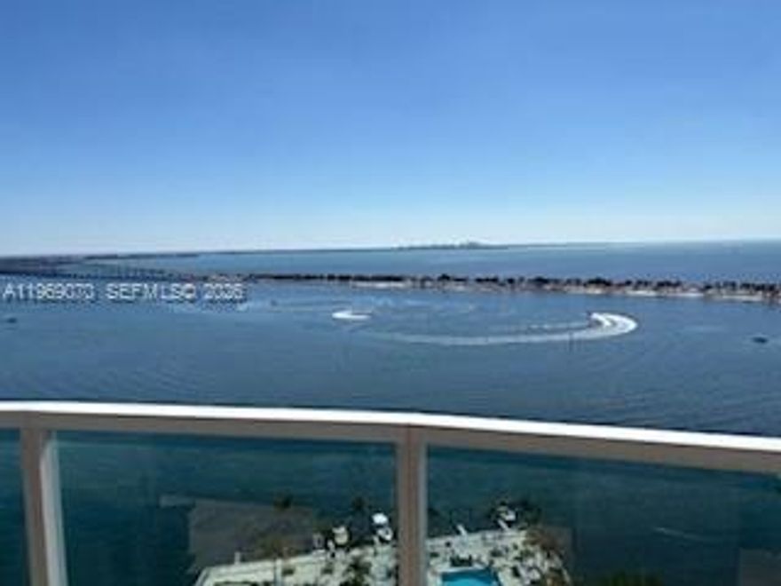 Direct and breathtaking bayfront views from this corner 2/2 spacious unit with floor to ceiling high impact windows and doors!  Open balcony, 2 covered assigned parking spaces (side by side), full service building with 24-hr front desk service, security, valet parking, marina, spa, sauna, fitness center, cafe/convenience store, BBQ area, tennis courts, party room and more! Great amenities!