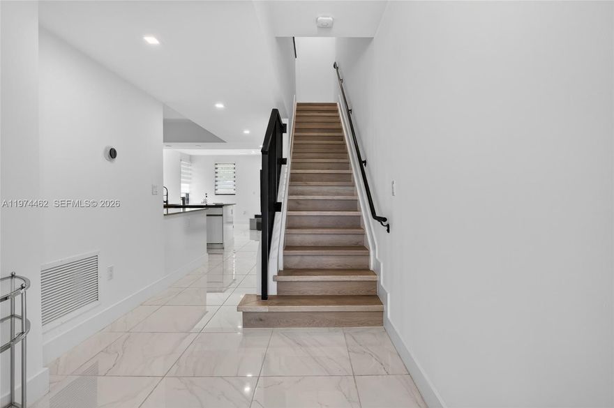 Spectacular 3-bedroom, 2.5-bath modern home in a boutique gated community built in 2024. This contemporary residence features a bright open floor plan with elegant porcelain tile flooring downstairs and wood-look vinyl upstairs. Beautiful kitchen offers stainless steel appliances, granite countertops, ample cabinetry, and a built in pantry. Impact windows throughout the entire home provide security, energy efficiency, and peace of mind. Built-in closets, stylish blinds and shades,  Cozy private patio—perfect for a BBQ and entertaining and much more..Move-in ready! Located in a prime Hollywood area near shopping, dining, places of worship, highways, and just minutes from the Hard Rock.