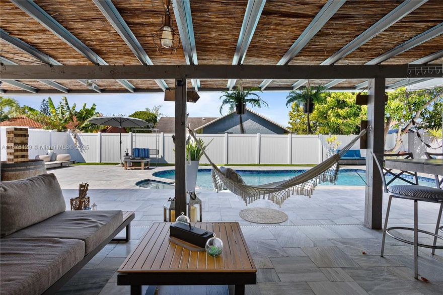 This stunning single-family home has been beautifully upgraded with a brand-new metal roof, offering both durability and modern look. The property features a potential 3rd bedroom are, currently used as the Florida entertainment area that can be converted to a 3rd BR. The exterior boasts a spacious circular driveway, providing a grand entrance with ample parking and effortless accessibility. Step inside to find a gorgeously remodeled kitchen featuring exquisite custom cabinets that blend style and functionality. The outdoor space is equally impressive, with a newly remodeled pool that serves as a private oasis—perfect for relaxation and entertaining. Complementing the home’s functionality, Every detail of this property has been thoughtfully designed to provide both luxury and practicality