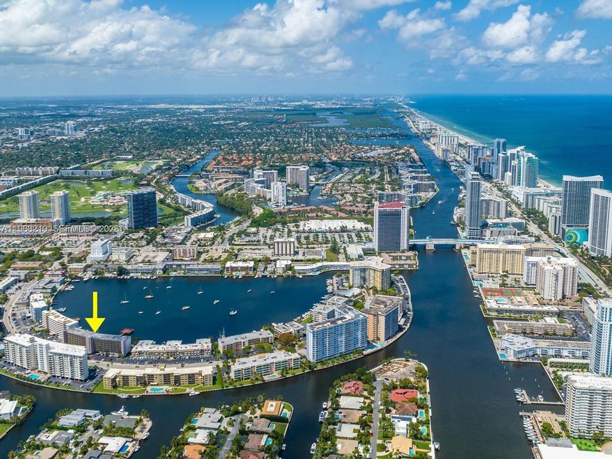 Experience the best of South Florida living in this private corner unit - a rare opportunity to enjoy peaceful waterfront living with unmatched outdoor features in a prime location. Step outside to a truly exceptional patio and backyard setting featuring a one-of-a-kind oversized dock that extends deep into the lake - perfect for relaxing, entertaining, or enjoying the serene waterfront lifestyle. Boats are conveniently docked along the rear, adding to the picturesque and tranquil atmosphere. The outdoor space also includes a barbecue area and a heated pool, both perfectly positioned to take full advantage of the breathtaking water backdrop. Just a few blocks from the beach and close to shopping, dining, and everyday conveniences, this location offers both relaxation and accessibility. Inside, the unit is fully furnished with tasteful, high-quality furniture and comes completely equipped with everything you need for comfortable living. One pet is welcome, making it a perfect home for animal lovers. Additional highlights include a covered garage parking space located directly beneath the unit, providing easy access while protecting your vehicle from the elements. Also available for a short-term 6-month lease during the summer months.