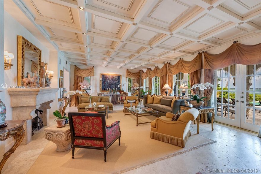 Seller Motivated! Enjoy wide Biscayne Bay and stunning sunsets over the Downtown Miami skyline from this magnificent 2-story waterfront Mediterranean Revival estate designed by renowned architect Martin Luther Hampton. 6BR/8+2BA (incl. 2 private guest suites), & a romantic interior courtyard w/fountain. An impressive Great Room w/fireplace & Pecky cypress beamed ceilings greets leading to an expansive living room w/coffered ceilings, Saturnia marble floors, fireplace & formal dining room all w/open bay views. An elegant 2nd floor master suite sports a private sitting room, large balcony to the bay & balcony to courtyard. Spacious His & Her marble master bathrooms each w/walk-in closets. Entertain outdoor w/a large pool, covered loggia, & summer kitchen. Boat dock & 75.6’ of waterfront.