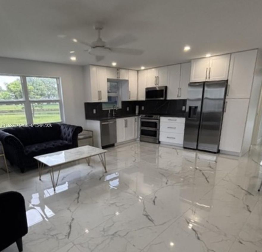 FULLY REMODELED WATERFRONT CORNER UNIT! Beautiful 1-bedroom, 1.5-bath first-floor corner condo located in the highly desirable Century Village East community. This move-in-ready residence has been completely updated and features recessed LED lighting, a new A/C system, new water heater, and new electrical panel.
Additional upgrades include floor to ceiling hurricane-impact windows and doors, marble-look porcelain tile flooring throughout, and custom built-in cabinetry.
The modern kitchen is equipped with energy-efficient stainless steel appliances, including a refrigerator, range, microwave, and dishwasher. The spacious primary suite offers a beautifully renovated bathroom with a walk-in shower and custom vanity. Enjoy breathtaking, unobstructed lake views from virtually every room, creating a peaceful and relaxing atmosphere.
Residents enjoy world-class amenities at the renowned Century Village clubhouse, including a state-of-the-art fitness center, indoor and outdoor pools, a 1,600-seat theater, billiards, library, arts and crafts studios, tennis and pickleball courts, courtesy transportation, and an endless variety of social, recreational, and educational activities. 
A rare opportunity to own a fully upgraded waterfront unit in one of South Florida's premier active adult communities. This is a non-rentable Condo – Cash Only – 55+ Community