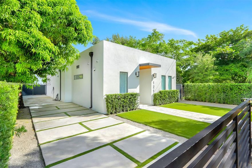 Built in 2022, this nearly 2,300 sq ft, 5 bed/3.5 bath Buena Vista home blends modern style, convenience, just one block from Miami's Design District. The main house offers 3 bedrooms, 2.5 baths, soaring 11-ft ceilings, and an open flow-through layout that extends seamlessly to an entertainer’s backyard with a resort-style pool, hot tub and covered terrace. The private, fenced 7,200 sq ft low maintenance lot features turf, concrete patio spaces, and two mature mango trees. The spacious primary suite includes a walk-in closet and spa-like bath. A separate 2-bedroom, 1-bath guest house with kitchenette is ideal for visitors, multi-gen living, or gym/office space. On a quiet street lined with new construction homes, this house is minutes from Wynwood, Brickell, Miami Beach, and the airport.
