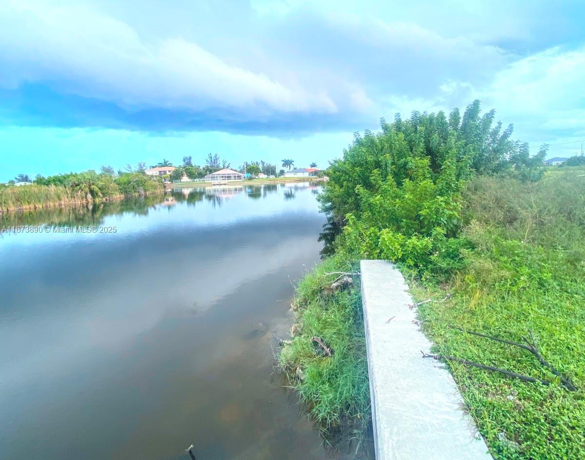 Build Your Future in Cape Coral! Discover this waterfront 0.24-acre lot in the heart of NW Cape Coral, offering endless potential to build your dream home. Bring your vision to life in one of the city’s fastest-growing neighborhoods. With no HOA restrictions, you can design your home exactly the way you want. Whether you’re planning a seasonal retreat, a year-round residence, or simply expanding your portfolio, this waterfront lot is a blank canvas for enjoying the warm, peaceful, and quiet lifestyle that Southwest Florida is known for. And if you're considering other options or a package deal, I also have another waterfront vacant lot at 3117 NW 9th St available For Sale—similar size and asking price.