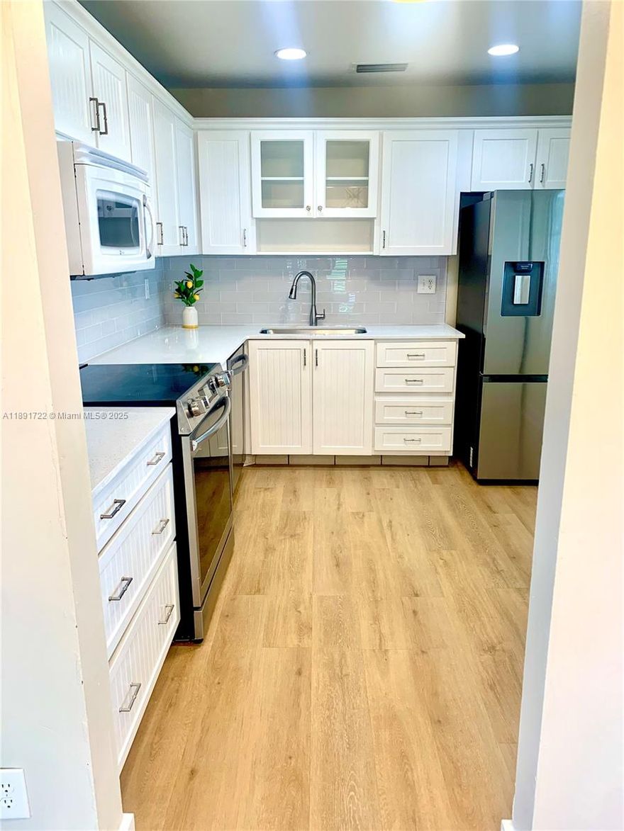 Remodeled Villa in a Peaceful 55+ Community! Everything has been done for your comfort and peace of mind, including recent installation of a New Electrical Panel / Breaker Box. Kitchen now has a Bright and Airy Feel, featuring Brand New Appliances, Beautiful New Quartz Countertops with a Modern Glass Backsplash, New Undermount Sink and Updated Lighting throughout. New Flooring and Baseboards. All these updates and still ONE OF THE LOWEST PRICED UNITS AVAILABLE IN PLANTATION!!! Additional Feature - This Villa has Great Additional Room that could be a perfect guest room, den, office, work-out area, crafting room. Options are endless! Located in a well-kept 55+ community with lots of amenities, this villa offers an unbeatable combination of value and lifestyle. Schedule your showing today!