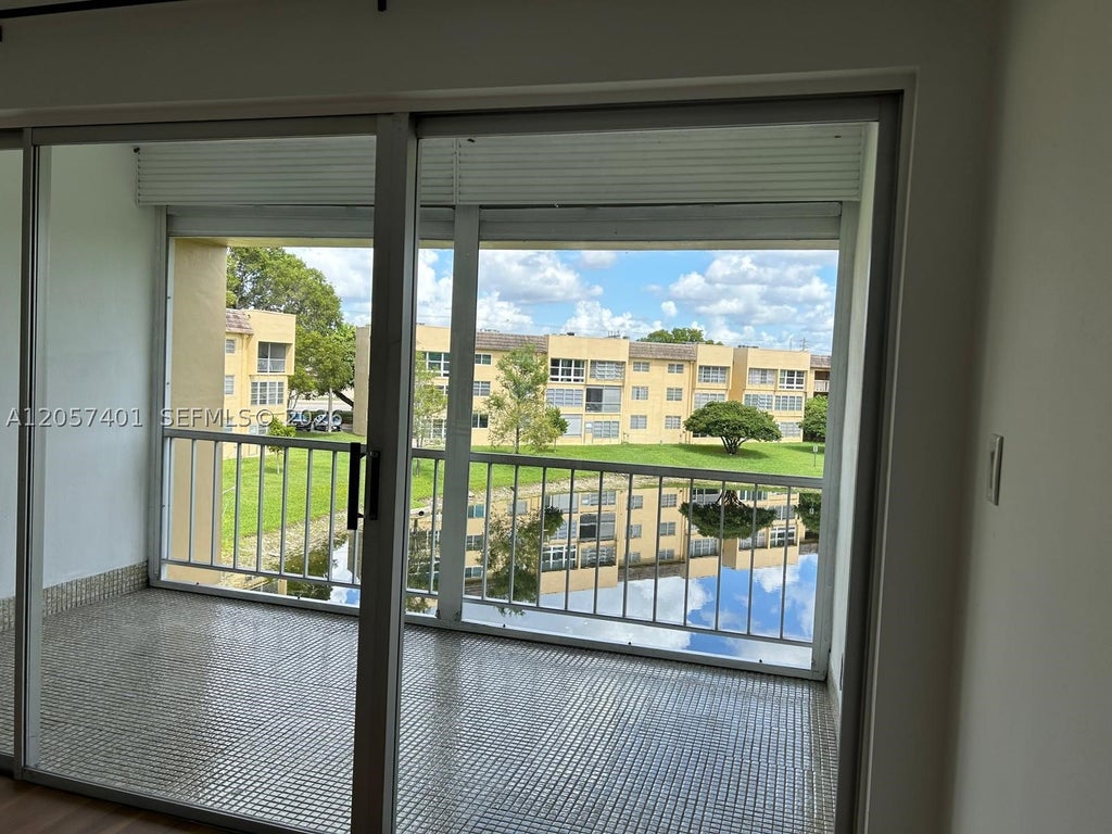 Photo of 6090 NW 64th Ave #311, Tamarac, FL 33319 (MLS # A12057401)