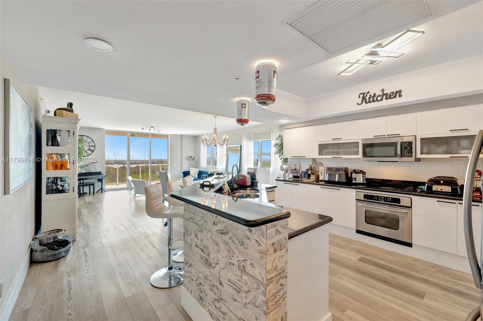 Unique opportunity to own a rarely available 2,385 SF living space for an amazing price. This charming renovated corner unit boasts an open floorplan, 3 bedrooms, large closets, ensuite bathrooms, a large den & half bath, beautiful wood-style flooring, spacious Kitchen with stainless-steel appliances, and new glass railing balcony with unobstructed panoramic views of the Oleta River Park, Crystal Lagoon & Miami skyline. Enjoy the clubroom, heated pool, gym, tennis court, playground, dog park, security, valet. Nestled in a vibrant new billion-dollar master-planned community, this emerging urban oasis will be one of the most sought-after neighborhoods, setting a new lifestyle standard with green spaces, parks, cafes, restaurants, retail, the Reserve Padel Club & the UHealth Medical Center