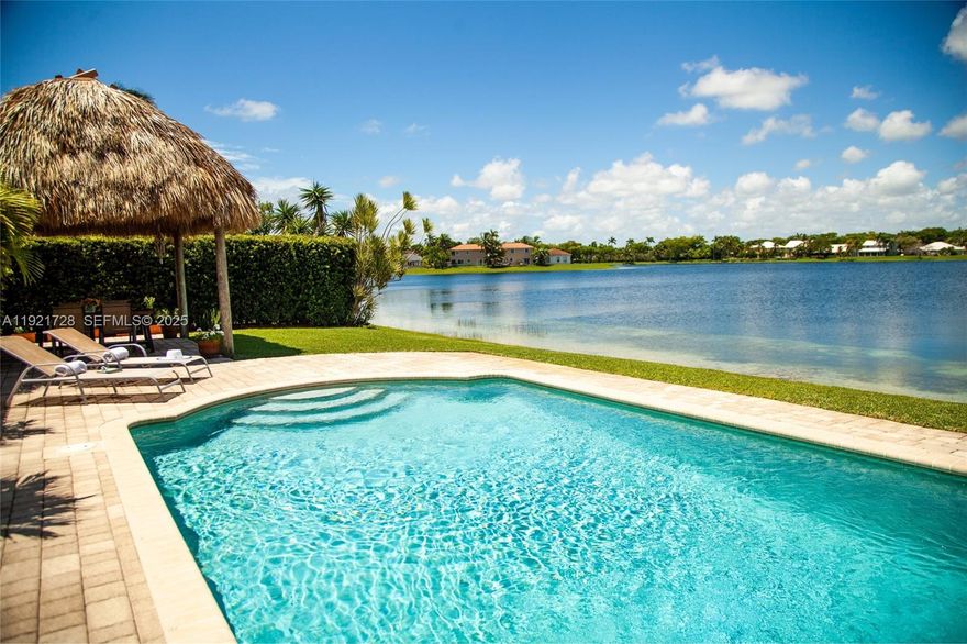 Experience true Florida lakefront living with year-round sunsets!
Lakefront pool home offering a calm, open layout and unobstructed water views from the main living areas and primary suite. Bright interiors, natural tones, and wood accents create a warm atmosphere. The backyard features a covered tiki area with fan, perfect for gatherings, plus a portable grill and a Cuisinart griddle on wheels.
House features 3 bedrooms + office/flex room, 2 bathrooms, impact protection (accordion and/or impact windows), salt-system pool, sprinkler with well, smart alarm, remote lock, auto-on lights, camera system. Pets OK.
Home is sold FULLY FURNISHED with a warm, natural aesthetic and custom wood furniture, including artisan pieces and quality décor. Some art pieces are not included, but all electronics and fixtures are, making this property truly move-in ready and ideal for relocations. Please tour the house through the ATTACHED PHOTOS.
HOA is paid quarterly and averages $94/month. It covers lake maintenance and community aesthetics management. Prime location east of Old Cutler Road, close to top schools, parks, and Black Point Marina. Cutler Bay is a booming city in Miami-Dade, with plenty of attractions. The home is located at "Lakes by the Bay" community, close to Turnpike, taking just a 35-minute drive—outside rush hour—to reach Miami International Airport. Built in 1996 under the significantly improved 1994 Building Code. Great opportunity to own this unique home! Easy to show!