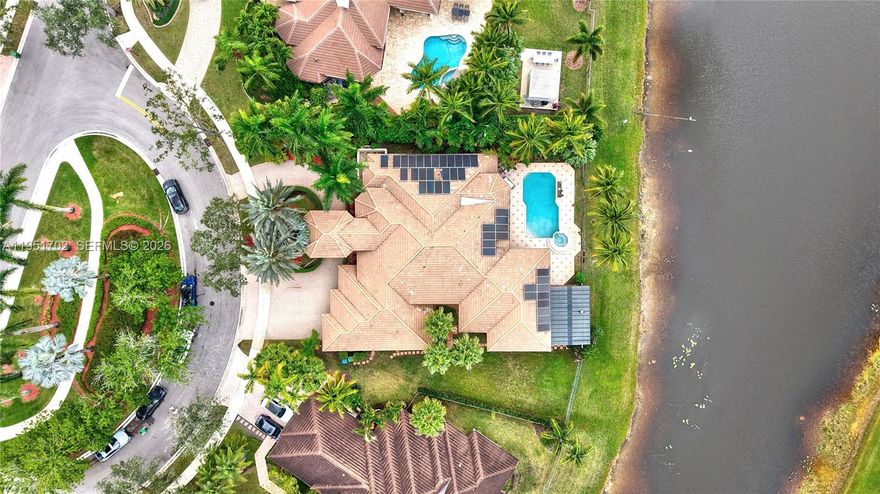 Stunning luxury residence set on an expansive 19,197 SF waterfront lot and cul-de-sac in the exclusive gated community of The Landings. This elegant home features soaring ceilings, full accordion hurricane protection, 5 bedrooms with upgraded ensuite bathrooms, half bath, and a dedicated home office. The principal suite offers a private office/gym and serene panoramic views of the pool and lake.
The chef’s kitchen showcases rich Italian-style cabinetry, quartzite countertops and backsplash, and brand-new top-of-the-line stainless steel appliances, it opens seamlessly to a warm family room and a stylish bar area—an ideal layout for entertaining with sweeping views of the pool and lake.
Outdoor living is elevated with a resort-style, salt water system pool, full summer kitchen, and grill area. A grand porte-cochere and circular brick-paver driveway create timeless curb appeal, complemented by a 3-car garage equipped with an electric vehicle charging station. Cul-de-sac. Every detail has been thoughtfully curated for the discerning buyer seeking luxury, comfort, and an unrivaled lifestyle. Water filtration system for all home.  
Located minutes from A-rated schools, parks, shopping, and Weston Town Center, this home delivers the lifestyle buyers seek in one of the city’s most desirable neighborhoods. Must see!