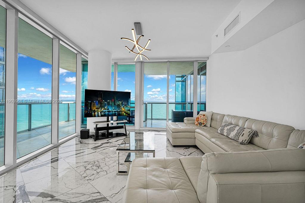 Experience luxury beachfront living in this 3-bed, 3.5-bath residence at Jade Ocean in Sunny Isles Beach. Located on a high floor, Unit 1808 offers breathtaking ocean and Intracoastal views. The 1,956 sq ft layout features a modern open design, floor-to-ceiling windows, and sleek finishes. Enjoy private elevator access, top-of-the-line appliances, and resort-style amenities including beach service, infinity pool, spa, gym, and 24/7 valet and concierge. Prime location near Bal Harbour and Aventura. A perfect blend of elegance, comfort, and coastal lifestyle.
