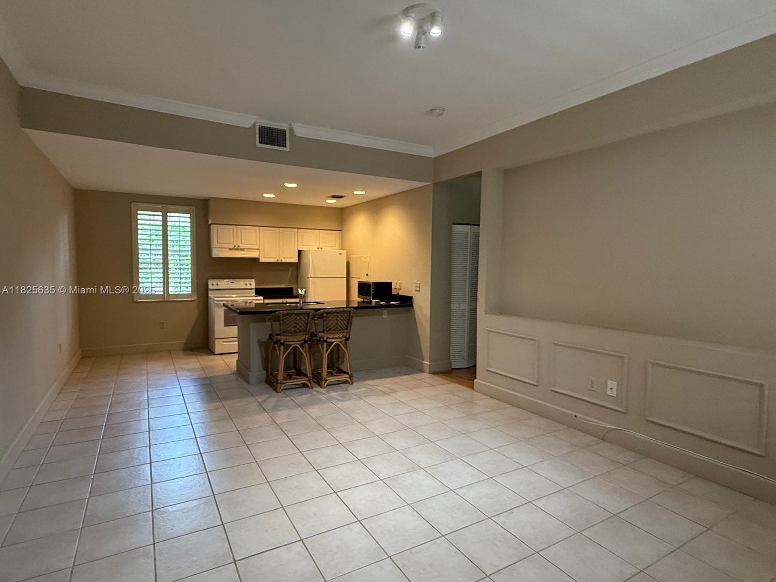 Spacious and well-maintained 1-bedroom, 1-bathroom apartment now available for sale! This inviting unit features elegant tile and wood-style flooring, abundant natural light, and a functional open layout. The kitchen offers granite countertops, white cabinetry, and essential appliances, along with a breakfast bar perfect for casual dining. The bedroom is generously sized, and the bathroom is clean and modern. Enjoy in-unit laundry hookups and a private patio space. Located in a desirable, well-kept community near shops, dining, and transit. Ideal as a primary residence or investment property.