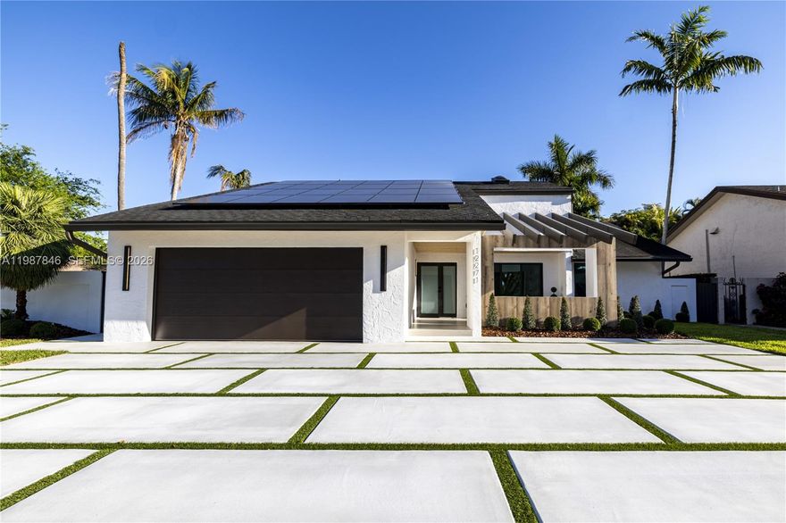 Welcome to this beautifully remodeled 3BR/2BA corner-lot residence, where exceptional curb appeal and thoughtful upgrades are evident from the moment you arrive. The home features a newer roof, impact-resistant doors and windows, and solar panels that provide energy efficiency and long-term savings, along with lush landscaping, a modern concrete driveway, and an inviting front porch. Step inside to soaring ceilings with skylights that fill the home with natural light, leading into a spacious open floorplan anchored by a large great room. The European-style kitchen is designed with sleek cabinetry, premium appliances, and a wine cooler, seamlessly blending style and functionality. The home continues with well-sized bedrooms, custom closet cabinetry, updated bathrooms, and refined interior lighting throughout. Out back, an expansive covered terrace creates the perfect space for entertaining or relaxing. Ideally located near top-rated schools, shopping, dining, and major roadways, this pristine, fully turnkey home offers the perfect balance of comfort, efficiency, and modern design.