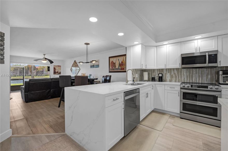 Unique opportunity to own this IMMACULATE, LAKE VIEW, 2-bedroom, 2-bathroom JASMIN model (1,207 SQ FT) located in one of the NEWEST and most desirable areas of Century Village—PLYMOUTH D (BUILT IN 1995). FIRST FLOOR LOCATION AND CAN BE RENTED RIGHT AWAY—A RARE AND HIGHLY DESIRABLE COMBINATION.

This beautifully maintained unit features a meticulously UPGRADED EAT-IN KITCHEN with stunning WATERFALL QUARTZ COUNTERTOPS, MODERN BACKSPLASH, and STAINLESS STEEL APPLIANCES. The spacious primary suite offers a LARGE WALK-IN CLOSET, and BOTH BATHROOMS HAVE BEEN UPGRADED. REMOVAL OF POPCORN CEILINGS throughout enhances the clean, CONTEMPORARY look and feel.

Additional highlights include HURRICANE SHUTTERS, IN-UNIT WASHER AND DRYER, and a SCREENED PATIO showcasing BREATHTAKING PANORAMIC LAKE VIEWS—perfect for relaxing and enjoying the serene surroundings.

Monthly maintenance is $716.94 (CVP $304.72 + Landmark $412.22) and includes water, sewer, trash, internet, and cable. **OK TO RENT**    Community amenities include clubhouse, multiple pools, fitness center, tennis courts, theater, organized activities, and courtesy transportation. Convenient access to shopping, dining, and medical facilities.    Easy to show.