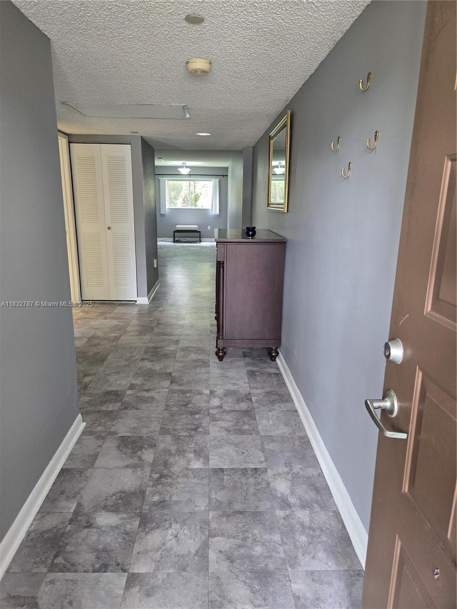 Nicely maintained large 1 bedroom, 1.5 bathrooms in a gated 55+ community. Located on the first floor with park like setting off screened in patio. Parking space located in front of unit. Washer and dryer in unit. Fantastic club house with movie theater, dance hall, pool, sauna, gym and more. Golf, on-site pharmacy. 24/7 gated security. New window blinds installed. Hurricane shutters on all windows. Newest section in Century Village. No rentals 1st 2 years of ownership. Courtesy bus to stores and malls. 650 credit score required.
