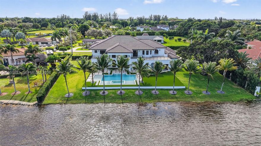 Opportunity knocks, SELLER SAYS SELL! Timeless elegance & luxury living in Davie, FL! This magnificent lakefront retreat boasts 9,234 sqft of living area & sits on a 36,850 sqft lot overlooking the water. Double-height ceilings, spectacular chandeliers & mesmerizing water views welcome you as soon as you walk in. This home was fully redesigned & crafted with precision, every detail was hand selected & it shows. Brand new 2025 Roof. On the first level enjoy an exquisite chef's kitchen with double islands, top of the line appliances & a striking cascade hood. Also a separate dining area & bar perfect for gatherings, and a theater room for endless entertainment. LED lighting on walls giving it a modern touch. Beautiful iron cast staircase takes you to the 2nd level or you can use the elevator. The master bedroom is everyone's dream, it's a whole wing of almost 1,000 sqft featuring a bar with sink, separate seating area, French doors leading to the huge balcony overlooking the pool & lake area, and his & hers separate full baths each with its beautiful custom closet. The backyard is a showstopper with a unique pool & jacuzzi, covered area with a summer kitchen, turf and lots green areas for outdoor activities, designed for simple maintenance so you can spend time enjoying it with the most relaxing view. Car lovers will love the 3 car garage, circular paved driveway & separate driveway on the side for extra space. Home feels grand, private & exclusive! Must see, Ready to close!